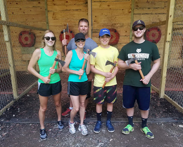 Family posing after axe throwing